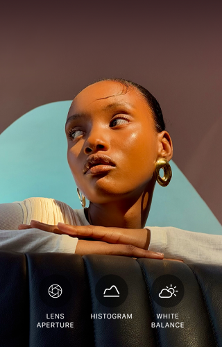 Close up portrait of a well-lit model with a colorful background, demonstrating the pro camera system's Pro controls UI: Aperture, Histogram, White Balance