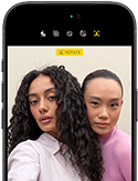 iPhone 18 Pro, black, front exterior, displaying two models posing for the camera, demonstrating the Center Stage front camera