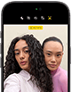 iPhone 18 Pro, black, front exterior, displaying two models posing for the camera, demonstrating the Center Stage front camera
