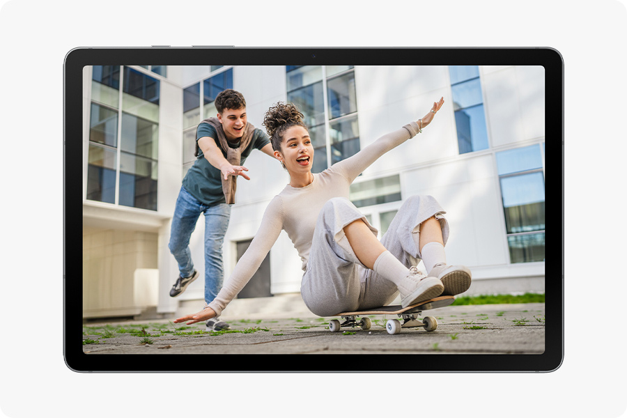 Galaxy Tab S10 Lite shows a photo of a woman sitting on a skateboard trying to balance as a man pushes her from behind.