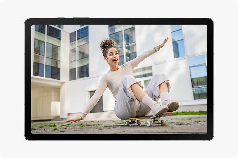 The edited photo shows the man removed, leaving the woman sitting alone on a skateboard, demonstrating a clean result after using Object Eraser.