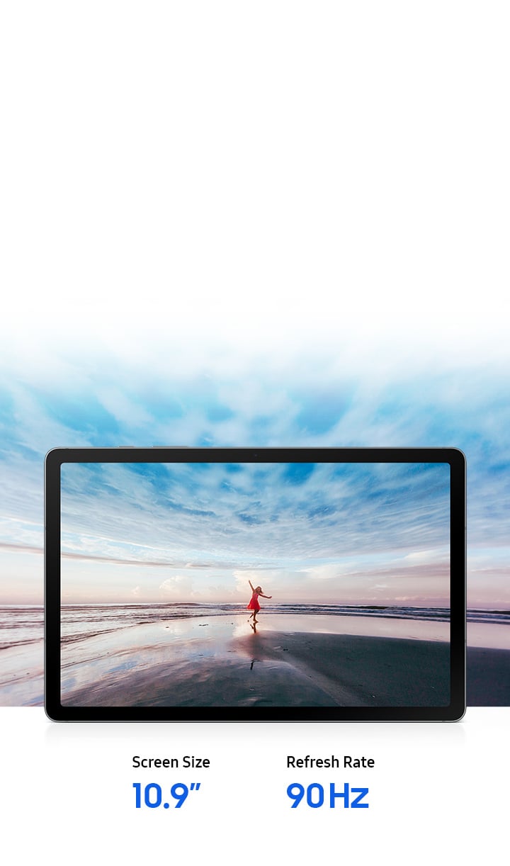 Galaxy Tab S10 Lite displayed horizontally showing a vivid image of a woman in red dress on the beach with arms outstretched against a blue sky and ocean horizon, expressing a free-spirited mood. The expansive scene extends beyond the screen edges, highlighting the large 10.9-inch display and immersive viewing experience that brings content to life. Text reads Screen Size 10.9-inch, Refresh Rate 90 Hz.