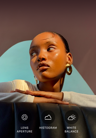 Close up portrait of a well-lit model with a colorful background, demonstrating the pro camera system's Pro controls UI: Aperture, Histogram, White Balance