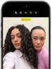 iPhone 18 Pro, black, front exterior, displaying two models posing for the camera, demonstrating the Center Stage front camera