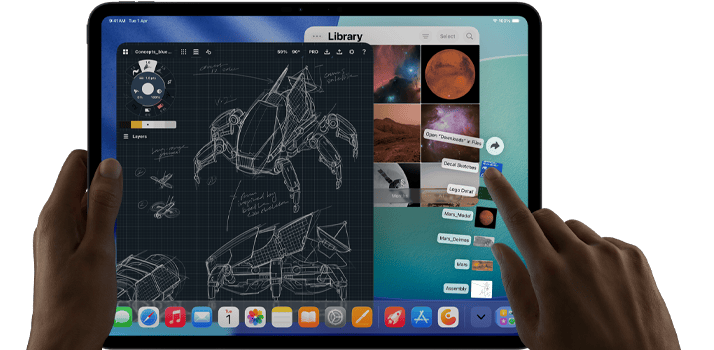 iPad Pro, space black color, left hand holding device, right hand pointing gesturing to manipulate multiple open app windows, a drawing app with sketches of mechanical designs, photos library of planets and space images, downloads folder files fanned out